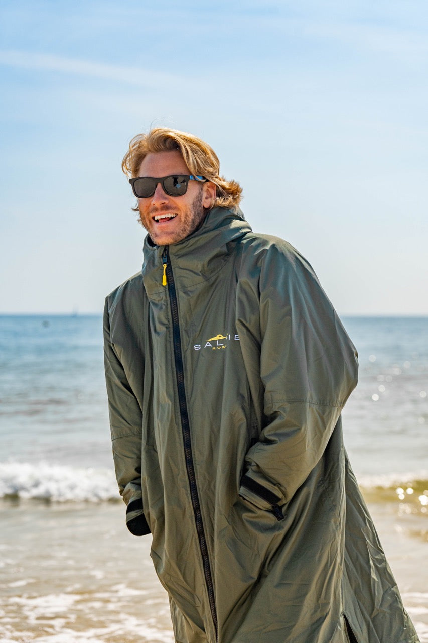 SALTIE Changing Robe in green, weather resistant, perfect for changing on the beach and made using 100% recycled materials. The SALTIE changing robe is designed keep you warm and dry during your sea swim, beach walks and all of your outdoor adventures.