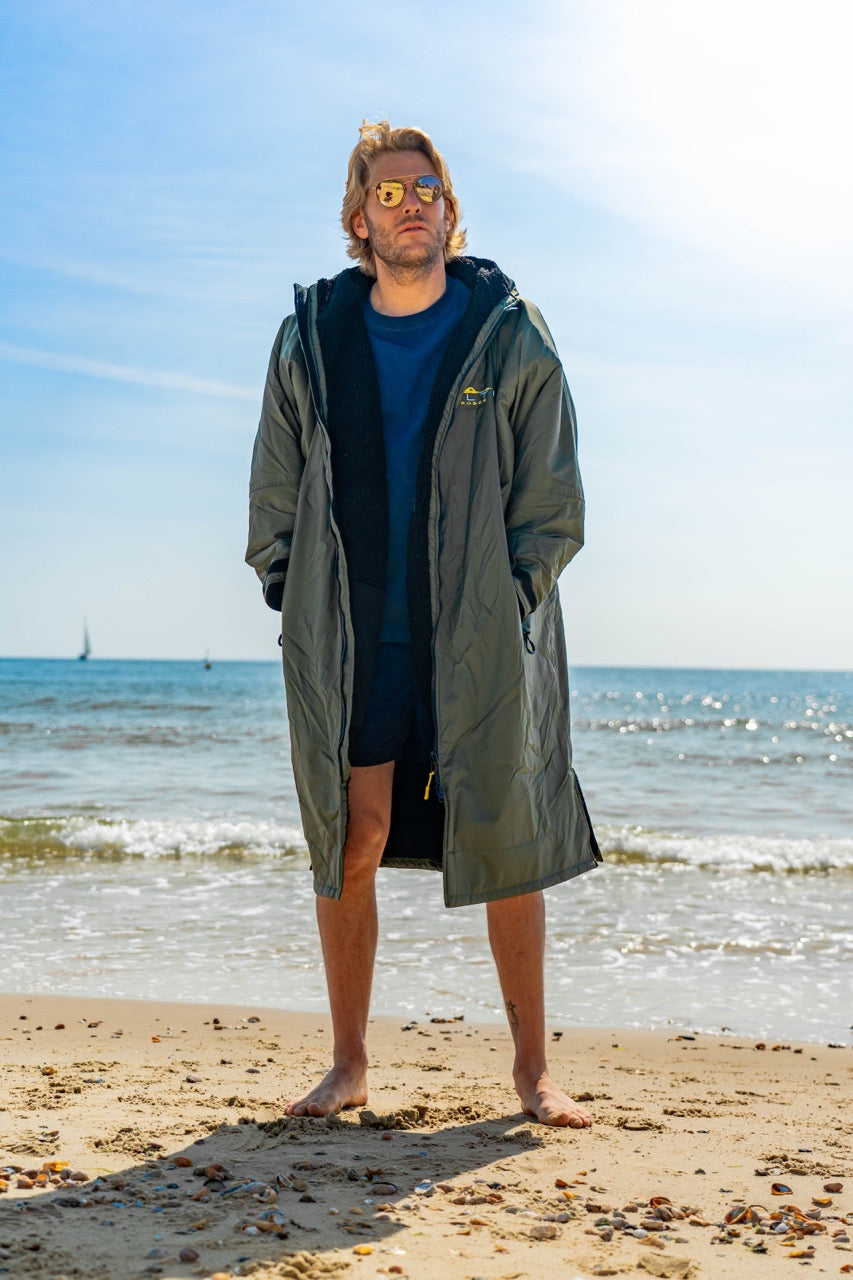 SALTIE Changing Robe in green, weather resistant, perfect for changing on the beach and made using 100% recycled materials. The SALTIE changing robe is designed keep you warm and dry during your sea swim, beach walks and all of your outdoor adventures.