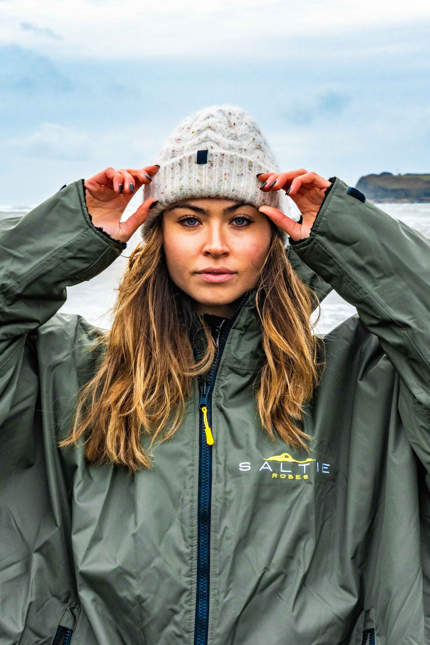 SALTIE Changing Robe in green, weather resistant, perfect for changing on the beach and made using 100% recycled materials. The SALTIE changing robe is designed keep you warm and dry during your sea swim, beach walks and all of your outdoor adventures.