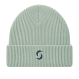 A sage green beanie against a white background with the "saltie" logo on the front.