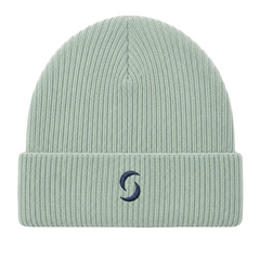A sage green beanie against a white background with the "saltie" logo on the front.