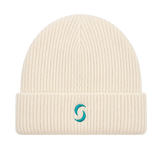 A beige beanie against a white background with the "saltie" on the front.