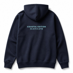 A branded saltie hoodie against a white background. The main colour is navy blue. The logo on the back is displaying the logo on the back which reads "Coastal edition" in a teal colour.