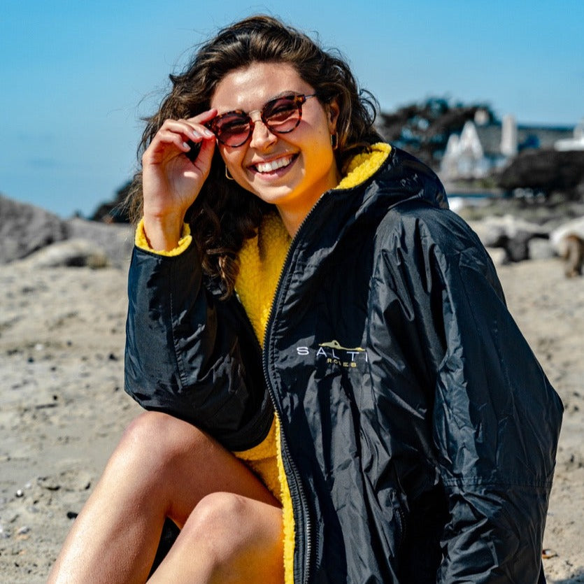 SALTIE Changing Robe in yellow, weather resistant, perfect for changing on the beach and made using 100% recycled materials. The SALTIE changing robe is designed keep you warm and dry during your sea swim, beach walks and all of your outdoor adventures.