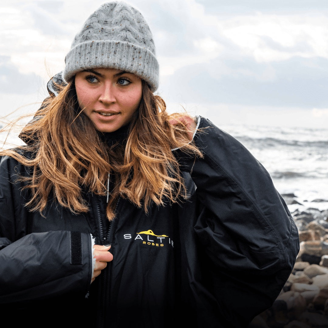 SALTIE Changing Robe in grey, weather resistant, perfect for changing on the beach and made using 100% recycled materials. The SALTIE changing robe is designed keep you warm and dry during your sea swim, beach walks and all of your outdoor adventures.