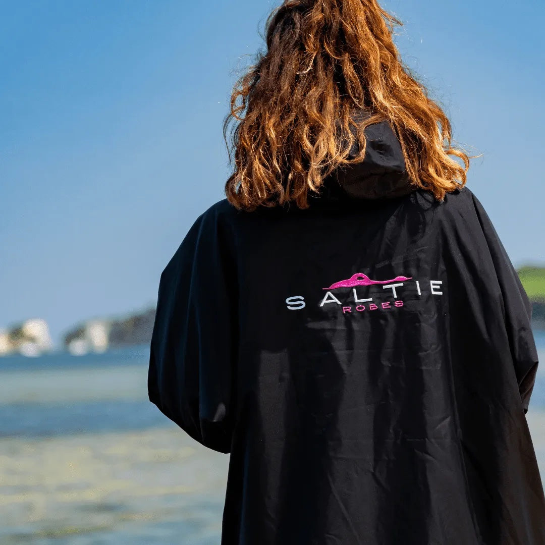 SALTIE Changing Robe in pink, weather resistant, perfect for changing on the beach and made using 100% recycled materials. The SALTIE changing robe is designed keep you warm and dry during your sea swim, beach walks and all of your outdoor adventures.