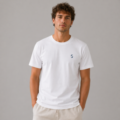 Man wearing a white t-shirt with a small logo on a gray background